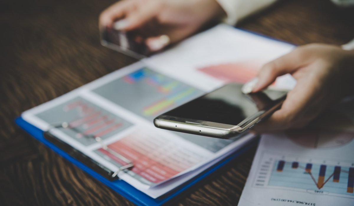 Woman holding credit card and using smart phone for online shopping with vintage tone.