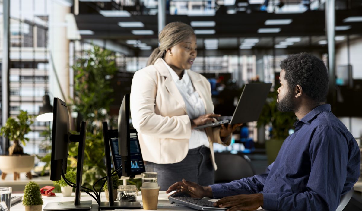 Work team in the office engaged in infographics analysis for problem solving tasks, financial planning to support business growth and accomplish strategic objectives. Multinational company.